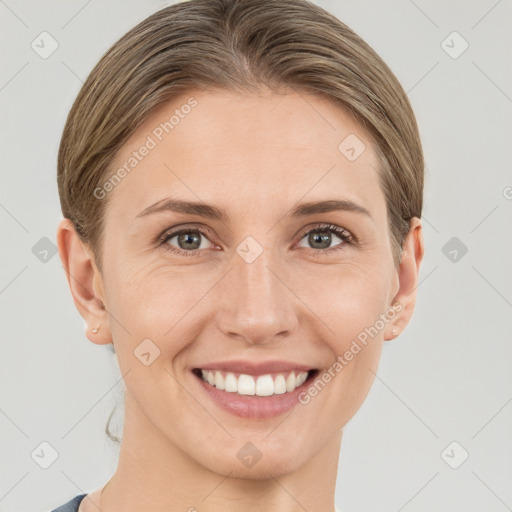 Joyful white young-adult female with short  brown hair and grey eyes