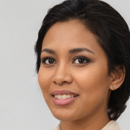 Joyful latino young-adult female with medium  brown hair and brown eyes