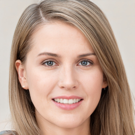 Joyful white young-adult female with long  brown hair and blue eyes