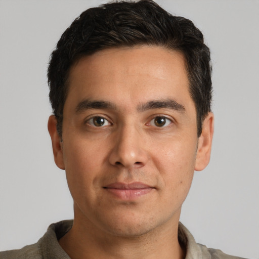 Joyful white adult male with short  brown hair and brown eyes