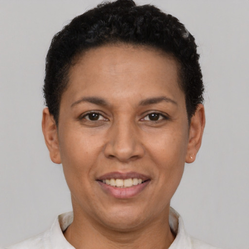 Joyful latino adult female with short  black hair and brown eyes