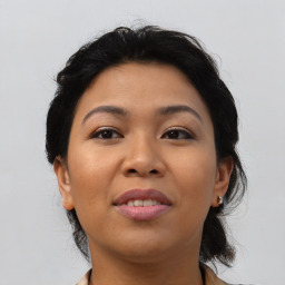 Joyful asian young-adult female with medium  brown hair and brown eyes