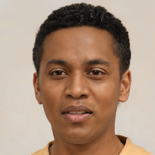 Joyful black young-adult male with short  black hair and brown eyes