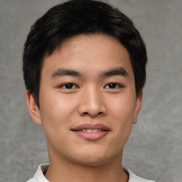 Joyful asian young-adult male with short  black hair and brown eyes