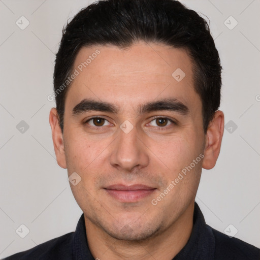 Joyful white young-adult male with short  black hair and brown eyes