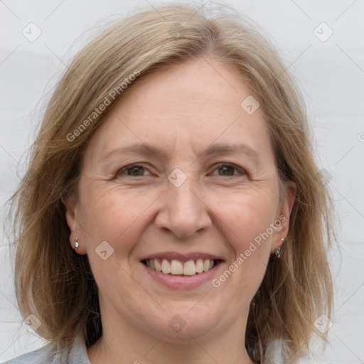 Joyful white adult female with medium  brown hair and grey eyes