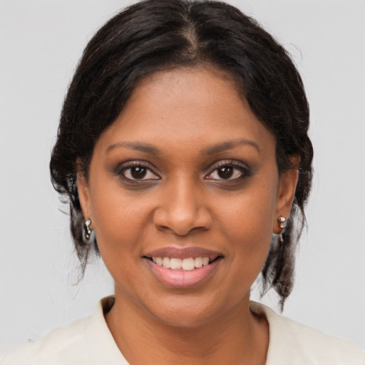 Joyful black young-adult female with medium  brown hair and brown eyes