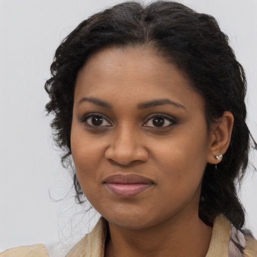 Joyful black young-adult female with long  brown hair and brown eyes