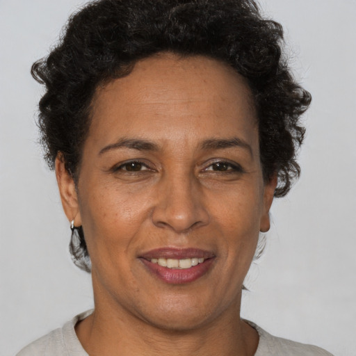 Joyful latino adult female with short  brown hair and brown eyes
