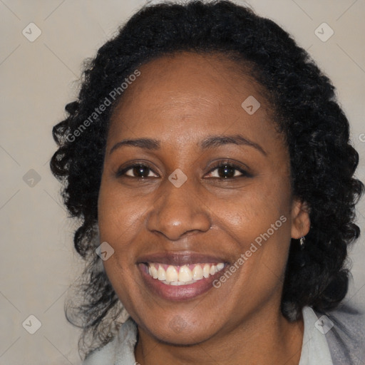 Joyful black adult female with medium  brown hair and brown eyes