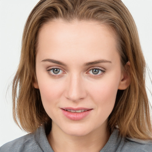 Joyful white young-adult female with long  brown hair and blue eyes