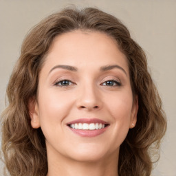 Joyful white young-adult female with long  brown hair and green eyes