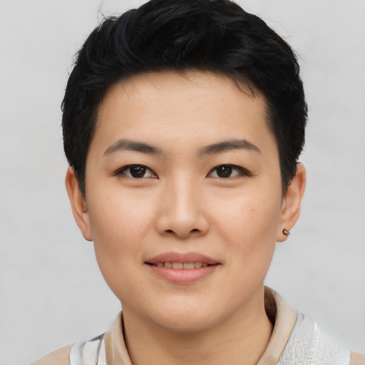 Joyful asian young-adult female with short  black hair and brown eyes