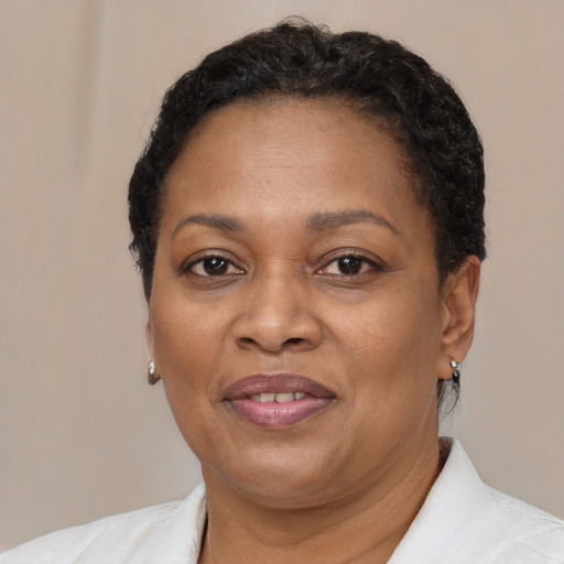Joyful black adult female with short  brown hair and brown eyes