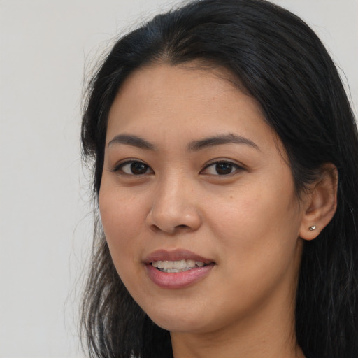 Joyful asian young-adult female with long  black hair and brown eyes