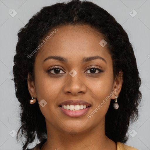 Joyful black young-adult female with long  brown hair and brown eyes