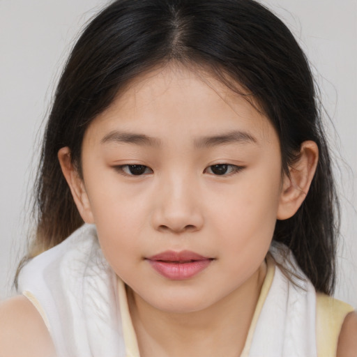 Joyful asian child female with medium  brown hair and brown eyes