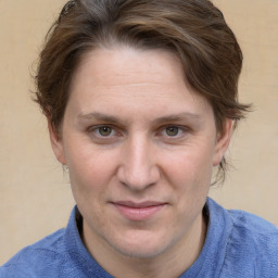 Joyful white adult female with medium  brown hair and blue eyes