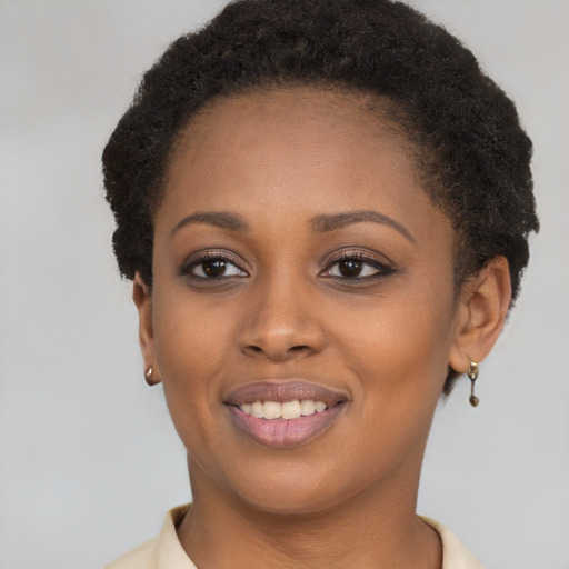 Joyful black young-adult female with short  brown hair and brown eyes