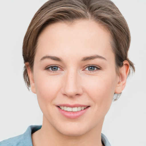 Joyful white young-adult female with short  brown hair and grey eyes