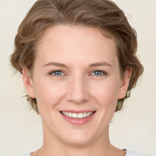 Joyful white young-adult female with medium  brown hair and green eyes