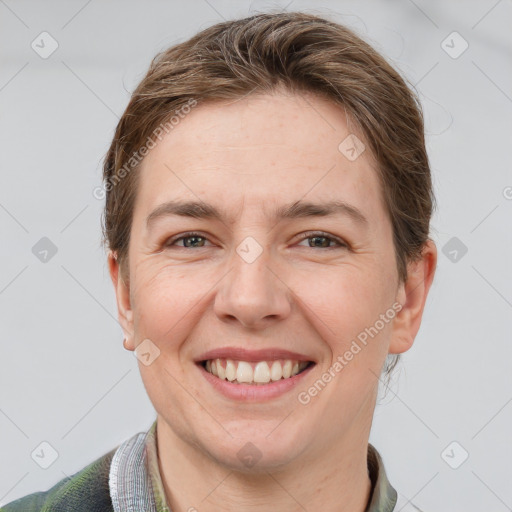 Joyful white adult female with short  brown hair and grey eyes