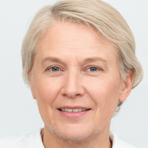 Joyful white middle-aged female with short  blond hair and brown eyes
