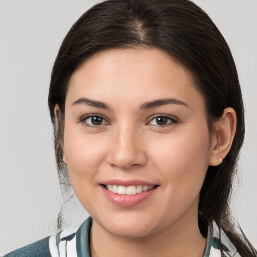 Joyful white young-adult female with medium  brown hair and brown eyes