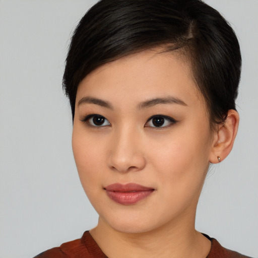 Joyful asian young-adult female with medium  brown hair and brown eyes