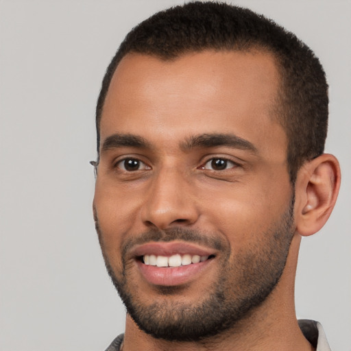 Joyful white young-adult male with short  black hair and brown eyes