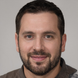 Joyful white young-adult male with short  brown hair and brown eyes