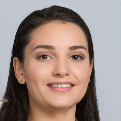 Joyful white young-adult female with long  black hair and brown eyes