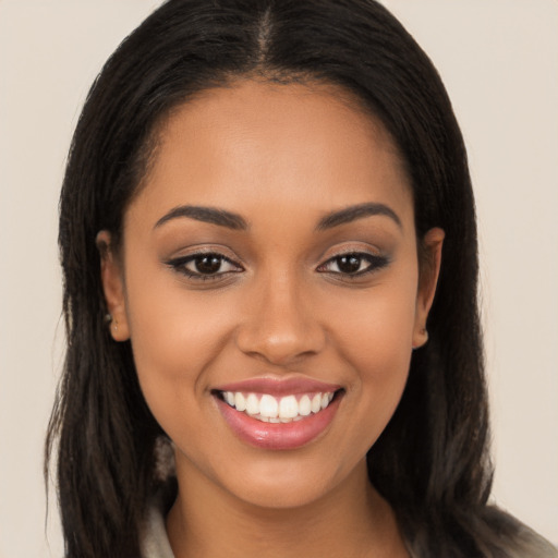 Joyful latino young-adult female with long  brown hair and brown eyes