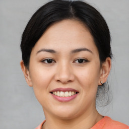 Joyful asian young-adult female with short  black hair and brown eyes