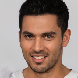 Joyful white young-adult male with short  brown hair and brown eyes