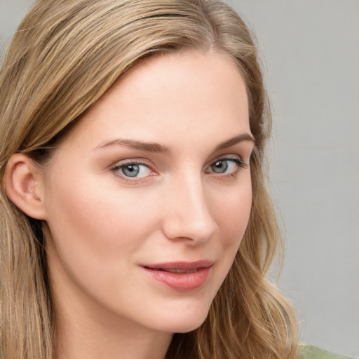 Joyful white young-adult female with long  brown hair and blue eyes