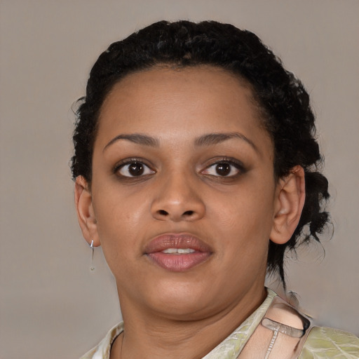 Joyful black young-adult female with short  brown hair and brown eyes