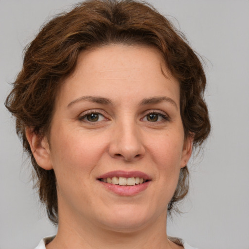 Joyful white young-adult female with medium  brown hair and green eyes