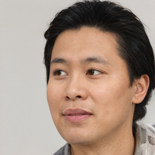 Neutral latino young-adult male with medium  black hair and brown eyes