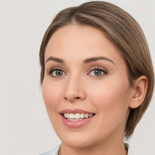 Joyful white young-adult female with medium  brown hair and brown eyes