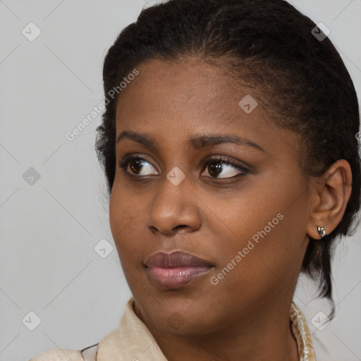 Joyful black young-adult female with medium  brown hair and brown eyes