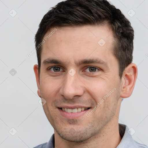 Joyful white young-adult male with short  brown hair and brown eyes