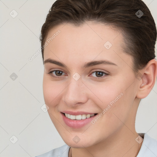 Joyful white young-adult female with short  brown hair and brown eyes