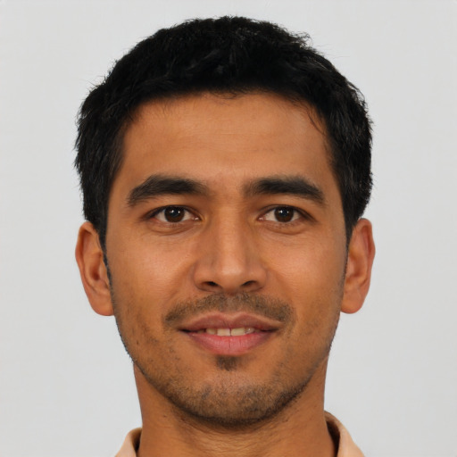 Joyful asian young-adult male with short  black hair and brown eyes