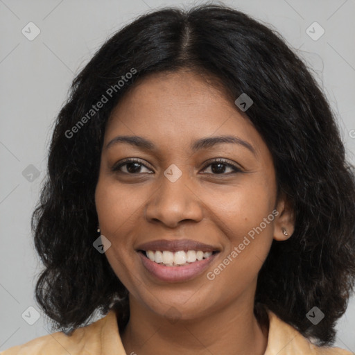 Joyful black young-adult female with long  brown hair and brown eyes