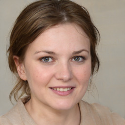 Joyful white young-adult female with medium  brown hair and blue eyes