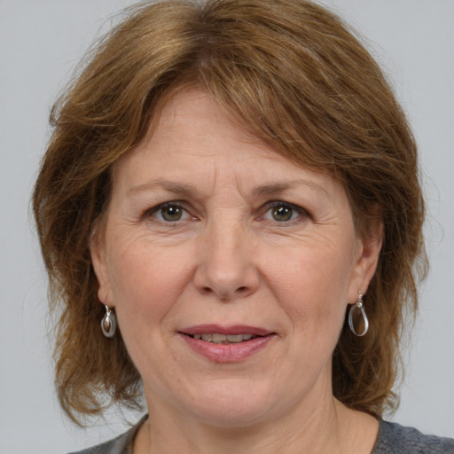 Joyful white adult female with medium  brown hair and grey eyes