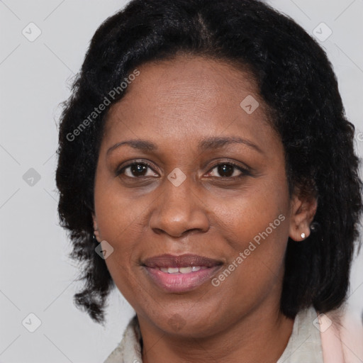 Joyful black adult female with medium  brown hair and brown eyes