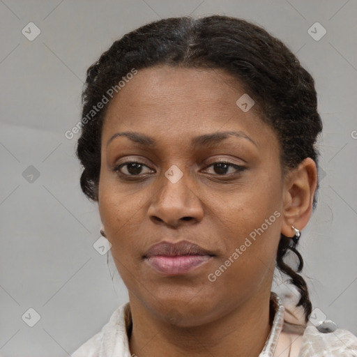 Joyful black adult female with short  brown hair and brown eyes