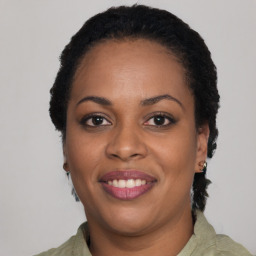 Joyful black adult female with short  black hair and brown eyes